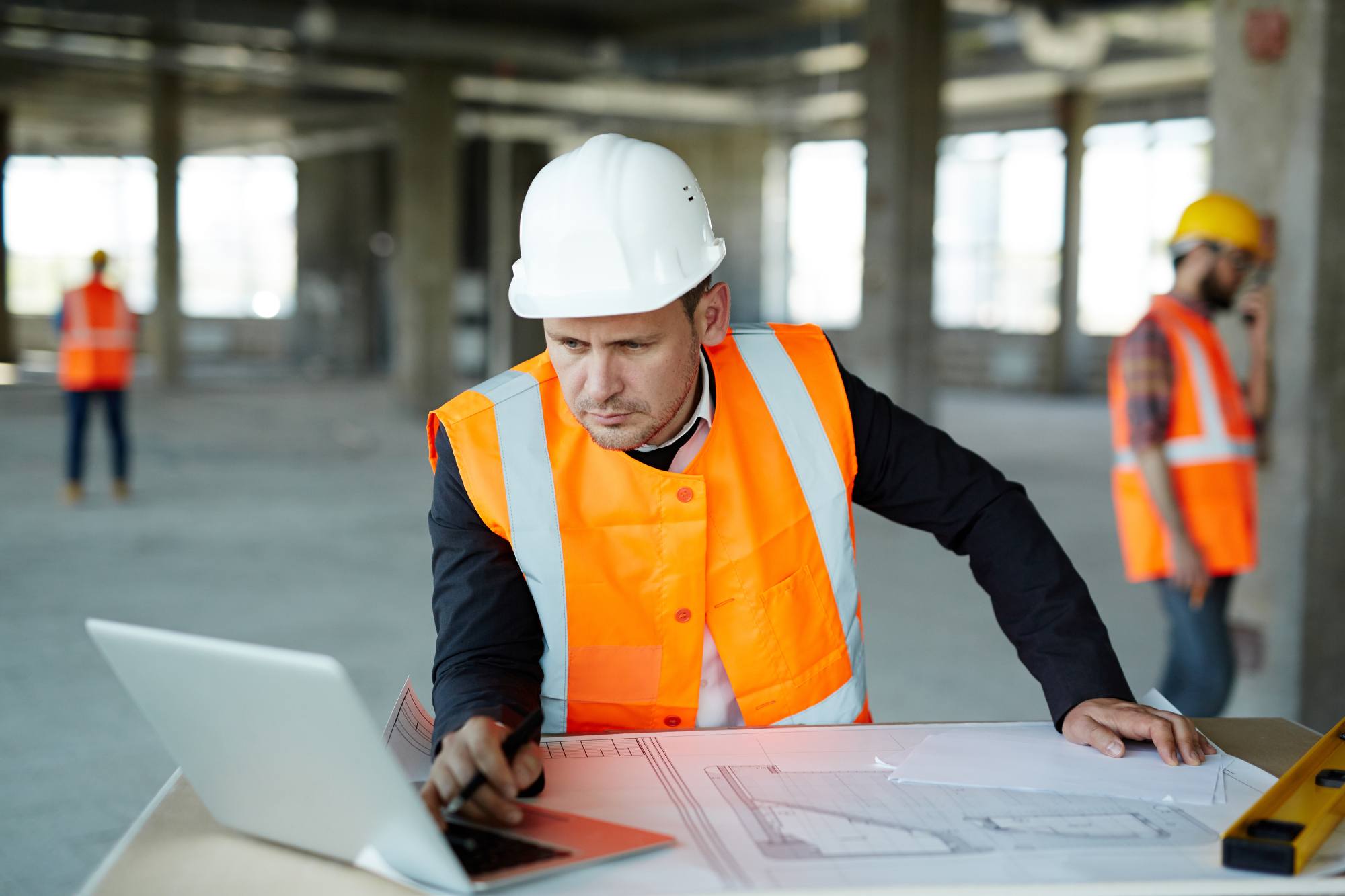An Arizona general contractor looks at plans for a Phoenix home renovation.
